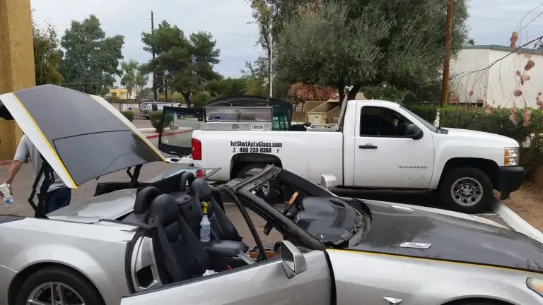 Technician replacing windshield on Cadillac XLR in Phoenix Arizona with professional auto glass tools