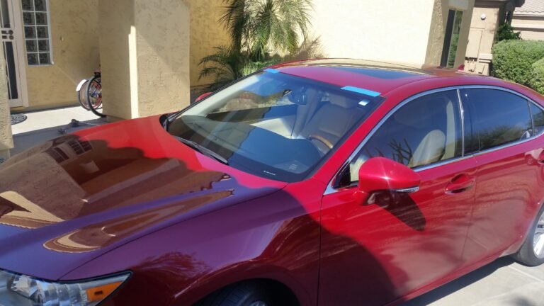 Technician installing OEM windshield on 2013 Lexus ES350 in Mesa Arizona
