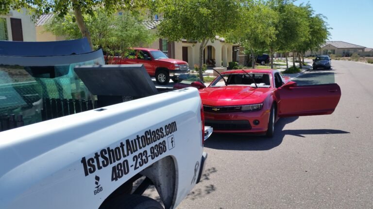 Technician replacing windshield on 2012 Chevy Camaro while maintaining remote start system functionality in Mesa Arizona