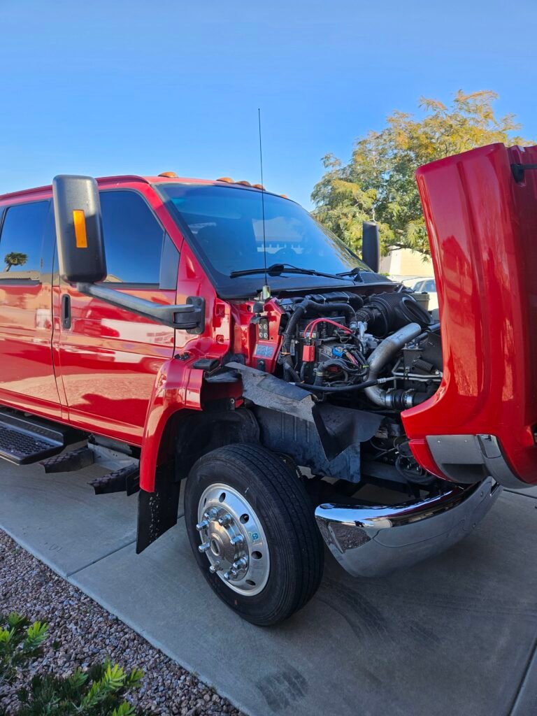 Technician replacing windshield on Chevy Kodiak truck in Gold Canyon Arizona with heavy duty auto glass equipment