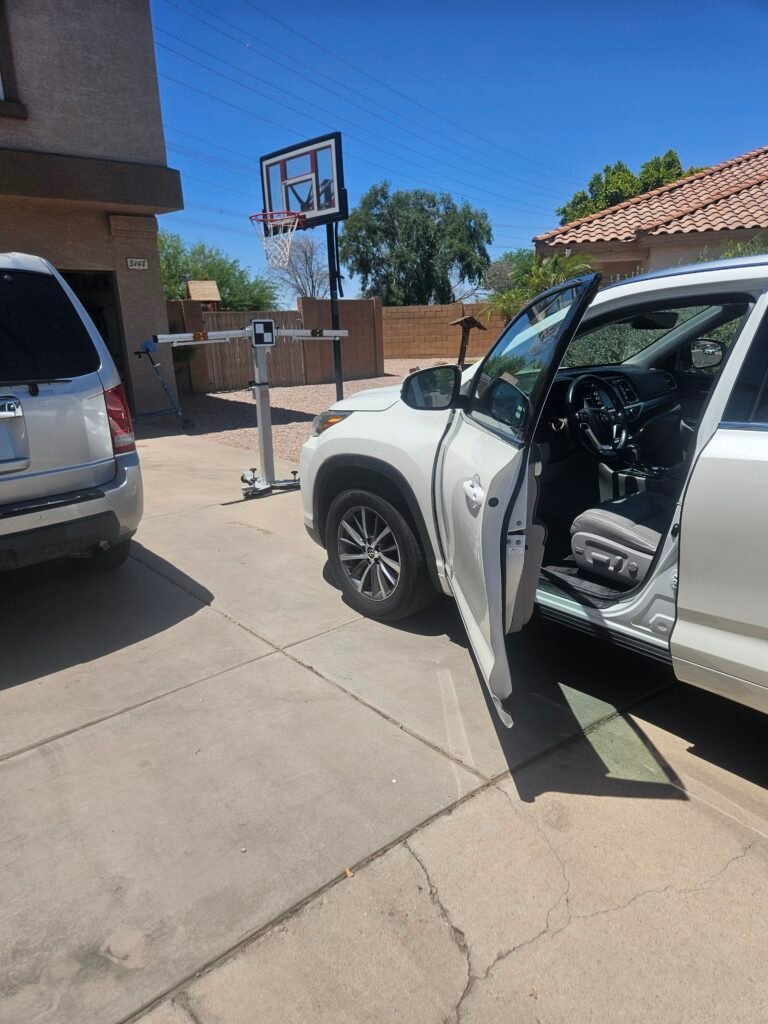 Behind-the-scenes view of a mobile windshield replacement and ADAS calibration setup for a 2018 Toyota Highlander in Mesa, Arizona.