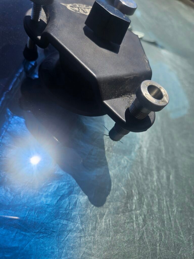 Professional windshield chip repair on a Toyota Sienna using a resin injection bridge in Mesa, Arizona.
