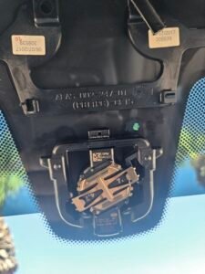 Factory rain sensor exposed on a 2018 BMW 530i after removing the mirror housing before windshield replacement in Mesa, AZ.