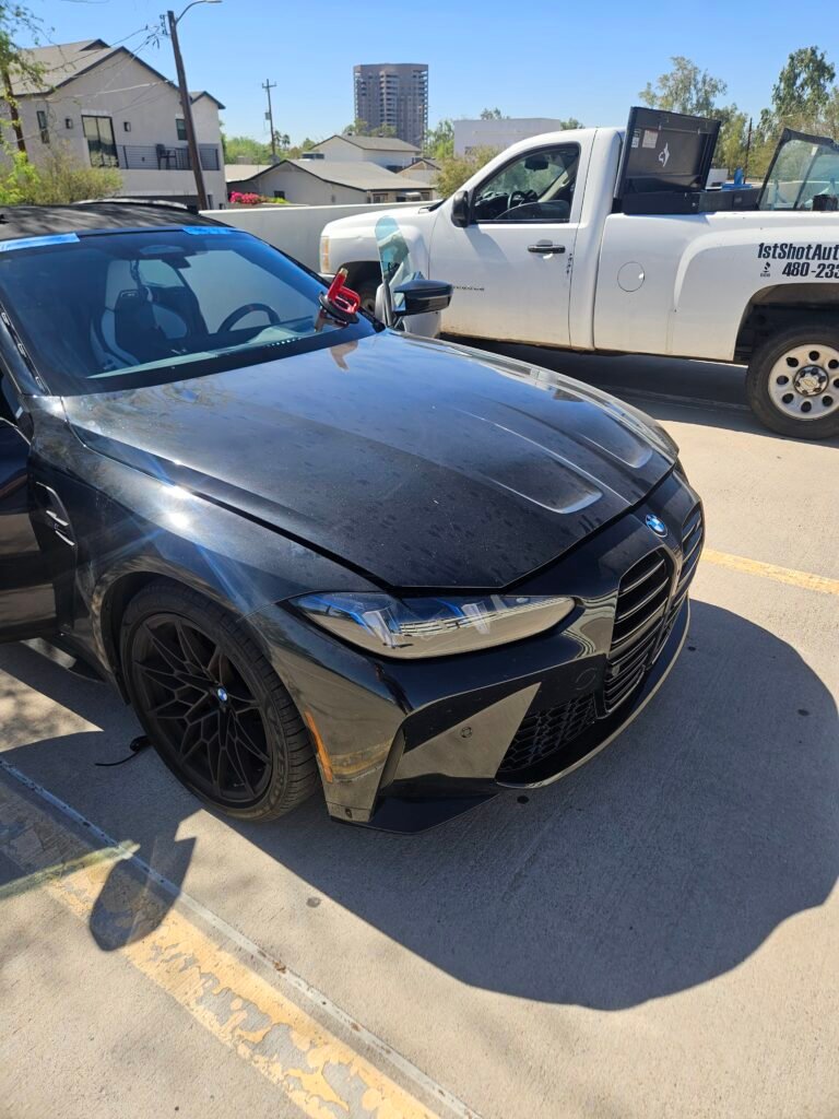 Mobile windshield replacement in progress on a 2026 BMW M4 in Phoenix, Arizona before dynamic ADAS calibration.