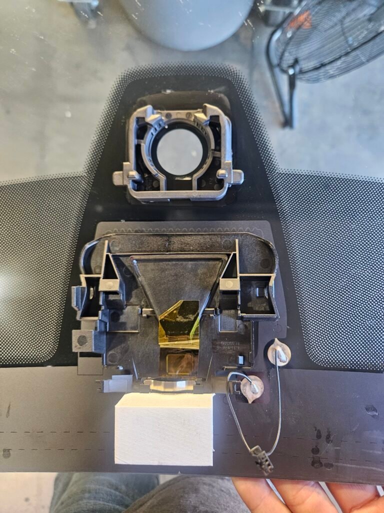 BMW rain sensor and lane departure warning camera mounting area during windshield replacement