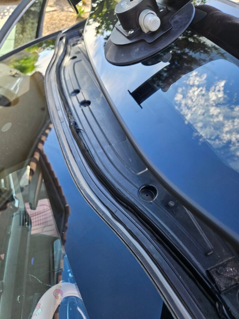 Technician installing roof glass on a 2023 Kia Sportage in Gilbert, AZ
