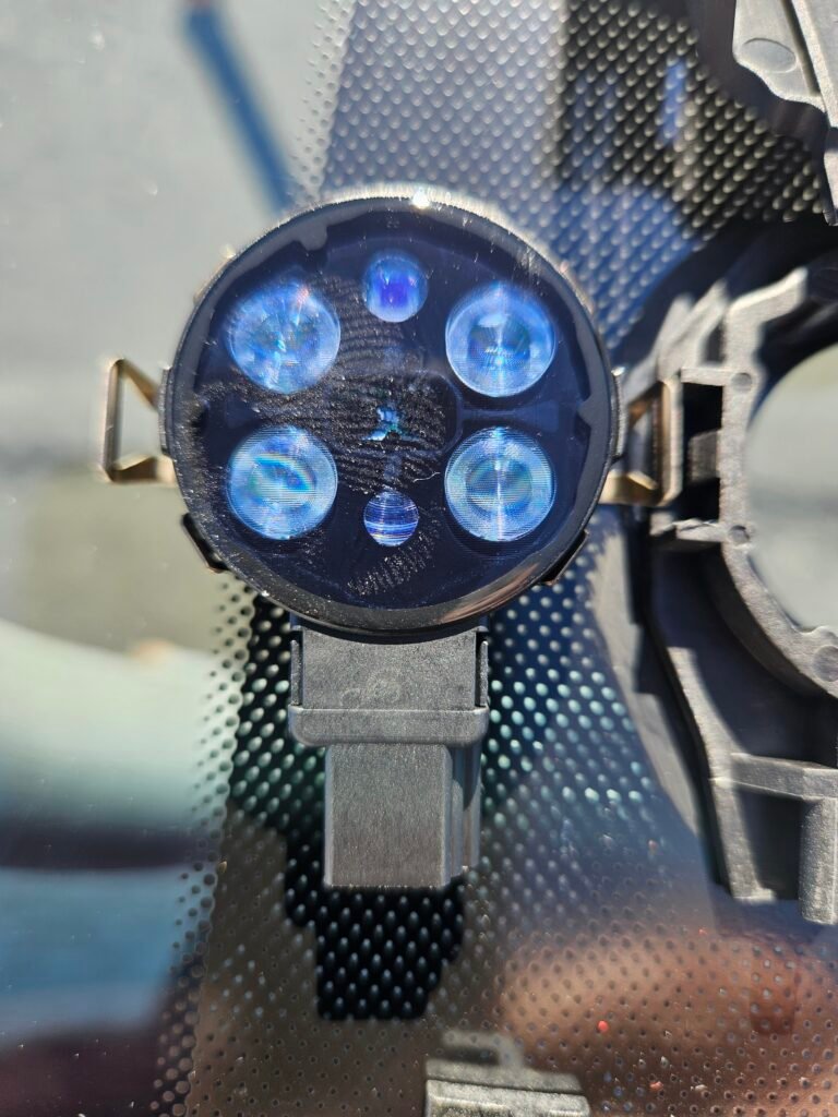 Original Hyundai Genesis rain sensor shown beside its corresponding windshield mounting location.