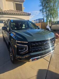 Green 2026 Chevrolet Suburban Z71 with newly installed windshield following mobile replacement in Mesa Arizona